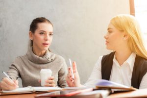 women discussing business resources