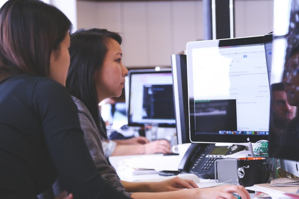 Two women undergoing software training