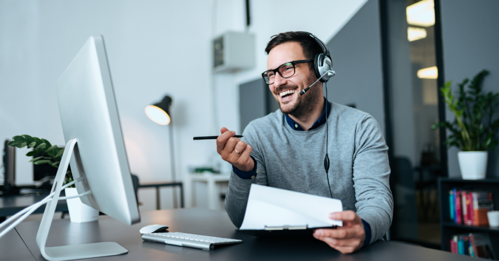 Man at a desk smiling at his learning opportunities